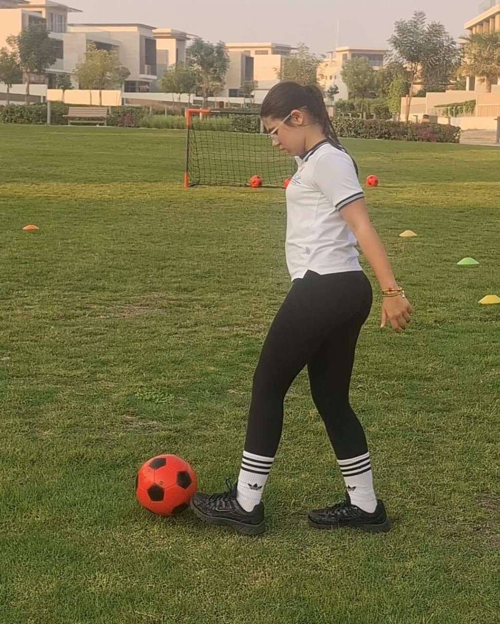 Player controlling the ball during a training drill on grass